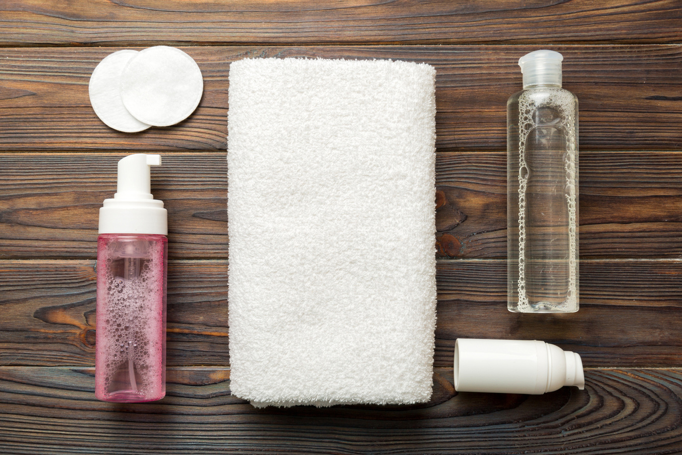 Micellar cleansing water and discs to remove cosmetics and cleanse the skin on colored background. Copy space top view